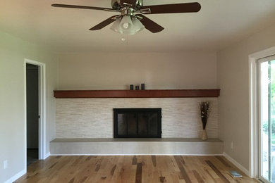 Inspiration for a transitional light wood floor living room remodel in Denver with beige walls