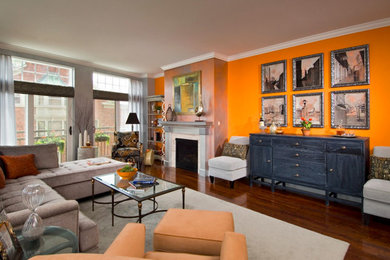Living room - mid-sized contemporary formal and enclosed dark wood floor living room idea in Boston with orange walls and a standard fireplace