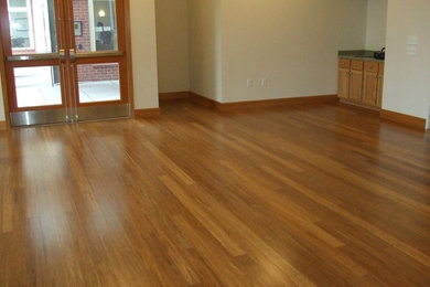 Mid-sized enclosed medium tone wood floor living room photo in Portland
