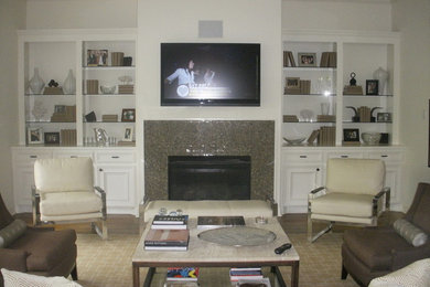 Example of a mid-sized trendy enclosed living room design in Houston with a bar and a wall-mounted tv