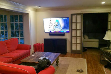Photo of an open plan living room in Richmond with beige walls, dark hardwood flooring and a wall mounted tv.