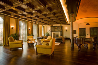 Großes, Repräsentatives, Offenes Klassisches Wohnzimmer mit beiger Wandfarbe, dunklem Holzboden, Kamin, verputzter Kaminumrandung und braunem Boden in New York