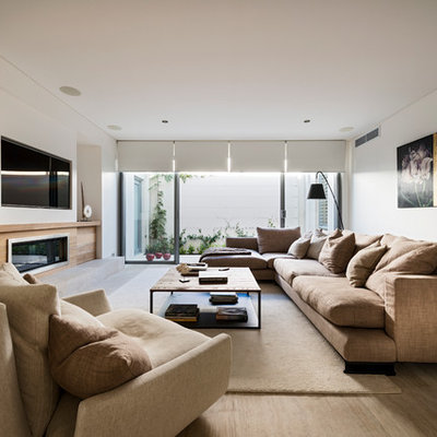 Large trendy open concept light wood floor living room photo in Perth with white walls, a ribbon fireplace and a media wall