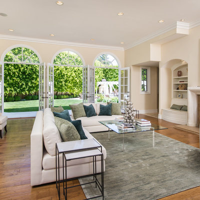 Living room - large transitional formal and enclosed dark wood floor and brown floor living room idea in Los Angeles with beige walls, a standard fireplace, a stone fireplace and no tv