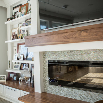 Inspiration for a mid-sized transitional formal and open concept medium tone wood floor living room remodel in Cedar Rapids with gray walls, a standard fireplace, a tile fireplace and a wall-mounted tv