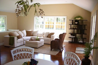 Example of a small transitional medium tone wood floor living room design in Cincinnati with beige walls