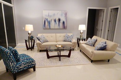 Example of a transitional enclosed ceramic tile living room design in Miami with gray walls and no fireplace