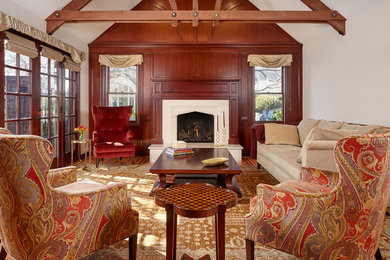 Elegant formal and enclosed medium tone wood floor living room photo in San Francisco with brown walls, a standard fireplace and a wood fireplace surround