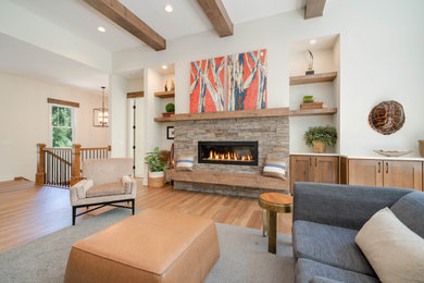Large eclectic open concept medium tone wood floor, brown floor and exposed beam living room photo in Grand Rapids with white walls, a standard fireplace and a stacked stone fireplace