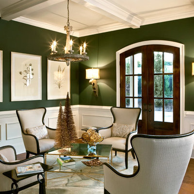 Example of a classic formal and open concept medium tone wood floor living room design in Charlotte with green walls