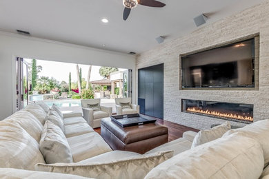 Inspiration for a living room remodel in Phoenix with a ribbon fireplace and a stone fireplace