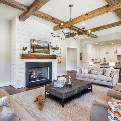 Large cottage open concept medium tone wood floor and brown floor living room photo in Other with gray walls, a standard fireplace, a metal fireplace and a wall-mounted tv