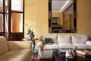 Large elegant formal dark wood floor living room photo in New York with beige walls