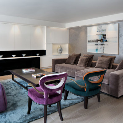 Example of a mid-sized trendy formal and enclosed medium tone wood floor and gray floor living room design in New York with gray walls, a ribbon fireplace and no tv