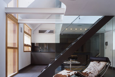 This is an example of a contemporary open plan living room in London with white walls and no tv.