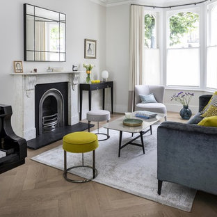 Inspiration for an expansive contemporary formal open plan living room in London with grey walls, medium hardwood flooring, a ribbon fireplace, a stone fireplace surround, no tv and grey floors.