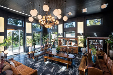 Inspiration for a huge transitional formal black floor living room remodel in Los Angeles with black walls, a standard fireplace, a stone fireplace and a media wall