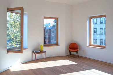 Small minimalist enclosed medium tone wood floor living room photo in New York