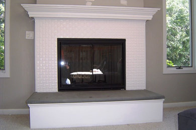 This is an example of a medium sized traditional formal open plan living room in Other with grey walls, carpet, a standard fireplace, a tiled fireplace surround, no tv and grey floors.