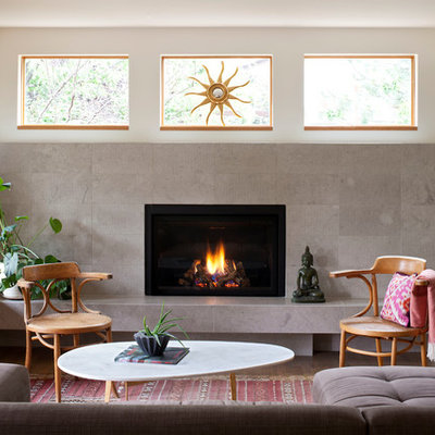 Example of a mid-sized trendy formal light wood floor and brown floor living room design in Denver with a standard fireplace, no tv, a tile fireplace and white walls