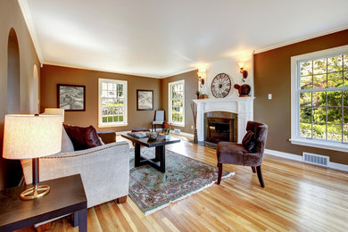 Light wood floor and multicolored floor living room photo in Atlanta with a standard fireplace and a plaster fireplace