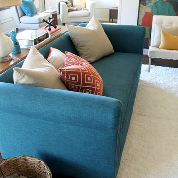 Peacock Teal Chesterfield Sofa with Orange and Teal Color Scheme  in Loft