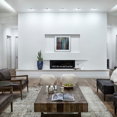 Inspiration for a large contemporary formal and open concept medium tone wood floor and brown floor living room remodel in Austin with white walls, a ribbon fireplace, no tv and a plaster fireplace