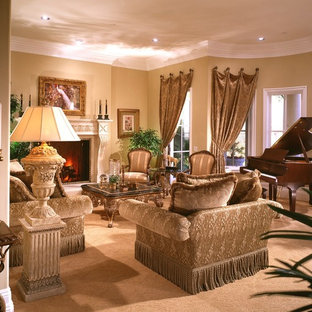 Inspiration for a large timeless open concept living room remodel in Los Angeles with beige walls, a standard fireplace, a stone fireplace and a media wall
