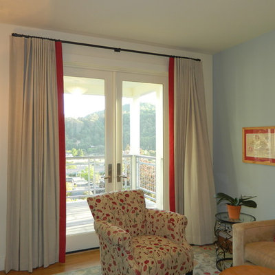 Living room - mid-sized traditional formal and enclosed medium tone wood floor living room idea in San Francisco with blue walls, no fireplace and no tv