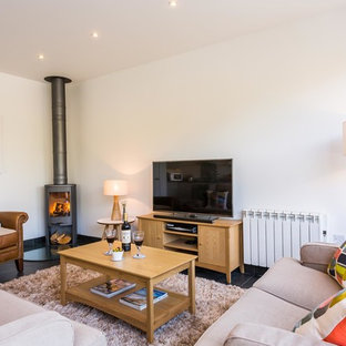 Idéer för att renovera ett funkis vardagsrum, med vita väggar, en öppen vedspis och en fristående TV
