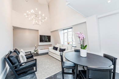 Mittelgroßes, Offenes Modernes Wohnzimmer mit weißer Wandfarbe, Gaskamin, verputzter Kaminumrandung, TV-Wand und grauem Boden in London