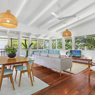 Mid-sized beach style open concept living room in Sunshine Coast with white walls, dark hardwood floors and brown floor.