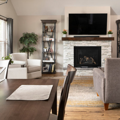 Example of a mid-sized transitional open concept light wood floor and brown floor living room design in Chicago with gray walls, a standard fireplace, a tile fireplace and a wall-mounted tv