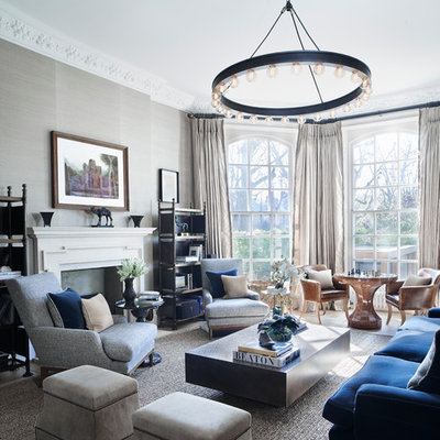 Inspiration for a large transitional formal living room remodel in London with gray walls, a standard fireplace and no tv