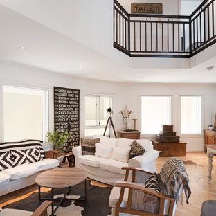 Eclectic living room in Sydney with white walls, medium hardwood floors and brown floor.