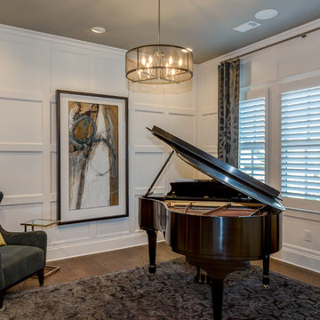 Piano Room off Foyer features paneled walls, floor to ceiling bookshelves & a ta