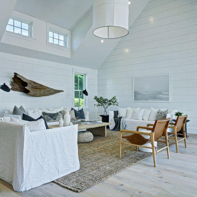 Living room - coastal formal light wood floor living room idea in Other with white walls and no fireplace