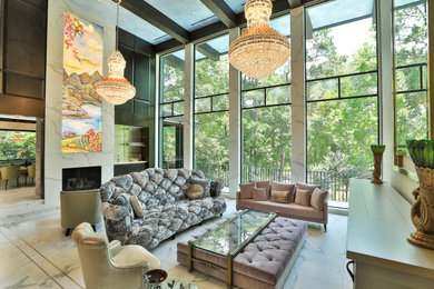 This is an example of a contemporary open plan living room in Houston with a standard fireplace and white floors.
