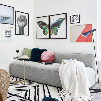 Small trendy open concept gray floor and vinyl floor living room photo in San Francisco with white walls and a wall-mounted tv