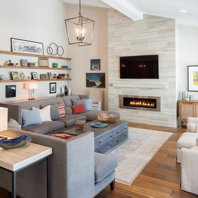 Inspiration for a large contemporary formal and open concept medium tone wood floor living room remodel in Grand Rapids with a ribbon fireplace, a metal fireplace, a wall-mounted tv and beige walls