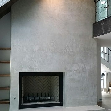 Polished concrete overlay on fireplace surround.