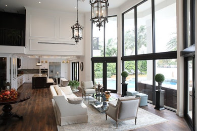 Example of a large classic formal and open concept dark wood floor and brown floor living room design in Miami with white walls, no fireplace and no tv