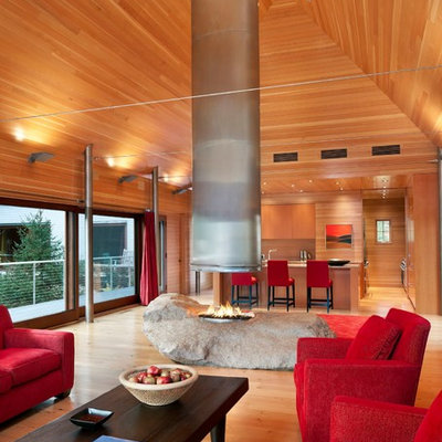 Living room - contemporary open concept living room idea in Portland Maine with a two-sided fireplace