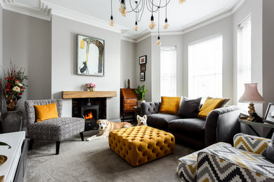 Design ideas for a contemporary formal and grey and yellow living room in Dorset with grey walls, carpet, a wood burning stove and no tv.