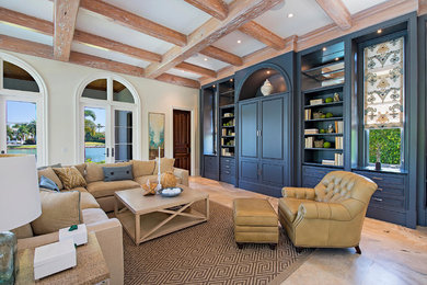 Inspiration for a mediterranean living room remodel in Miami with beige walls and a concealed tv