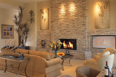 Example of a large trendy formal and open concept light wood floor and beige floor living room design in Los Angeles with beige walls, a standard fireplace, a stone fireplace and no tv