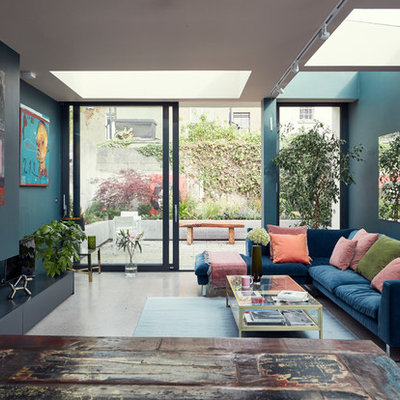 Living room - eclectic gray floor living room idea in Dublin with blue walls and a ribbon fireplace