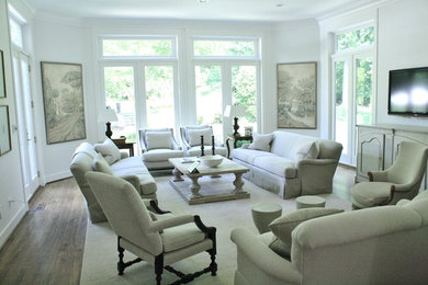 Large traditional enclosed living room in DC Metro with white walls, light hardwood flooring, no fireplace and a wall mounted tv.