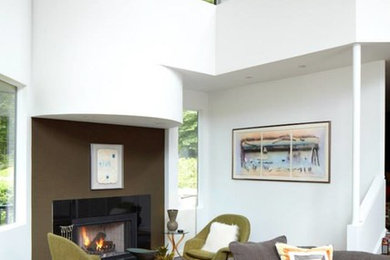 Inspiration for a large contemporary open concept light wood floor and brown floor living room remodel in New York with white walls, a standard fireplace and a tile fireplace