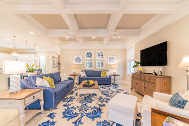 Example of a beach style beige floor and coffered ceiling living room design in Other with beige walls and a wall-mounted tv